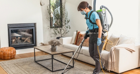Merry Maids Cleaning Professional Vacuuming a Rug