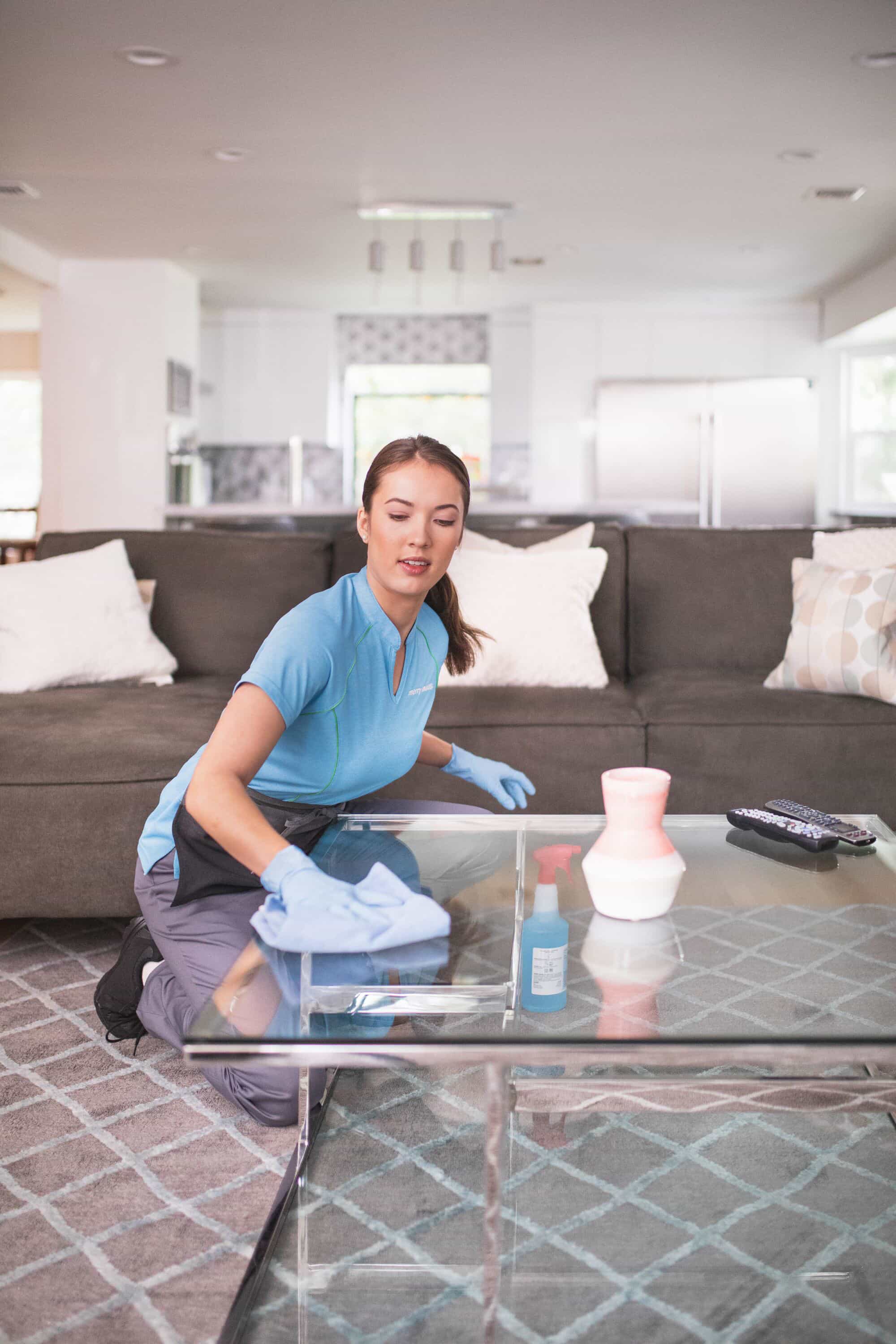 A Merry Maids team member sanitizing a table during maid service in Waltham, MA