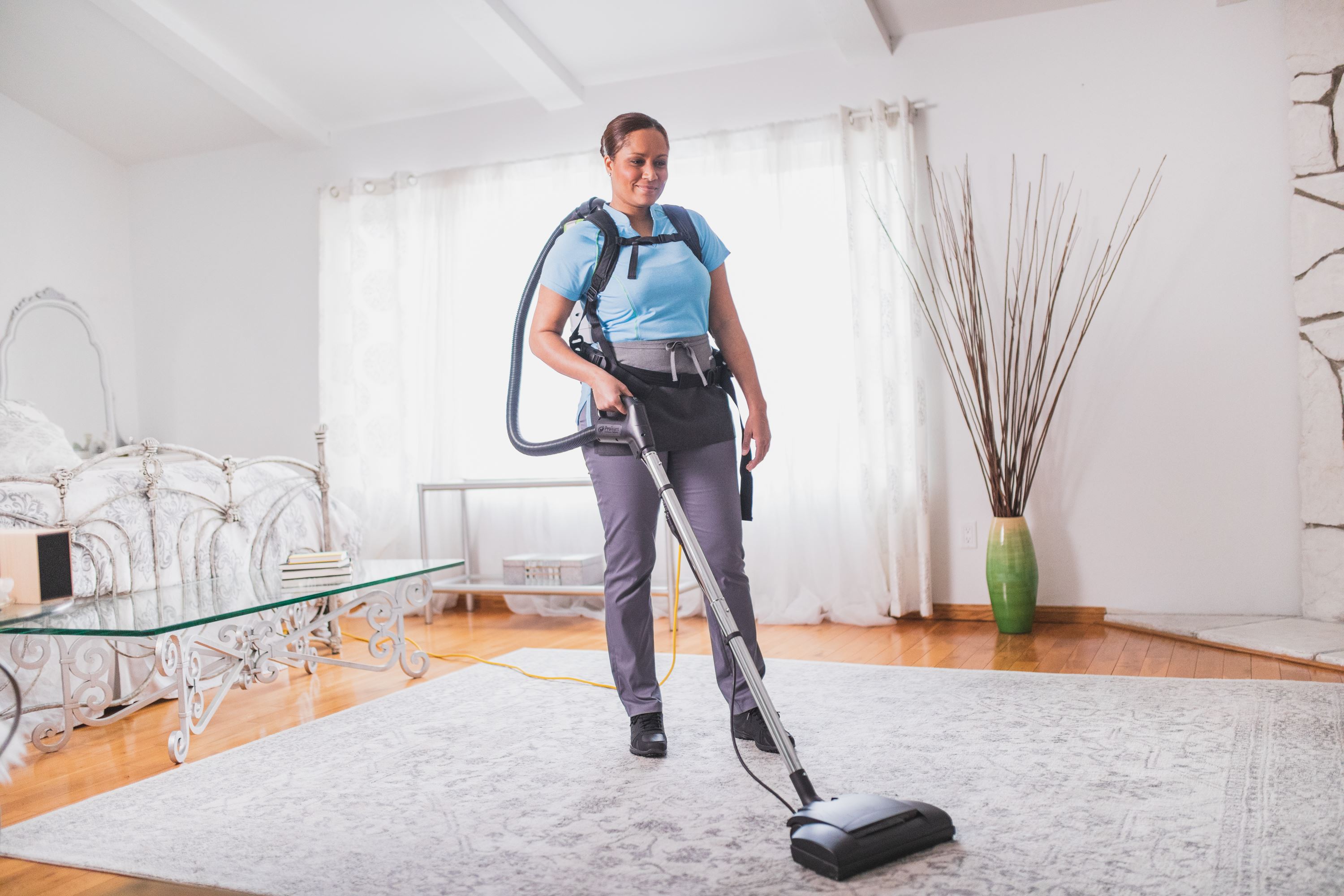 Merry Maids team member vacuuming during maid service
