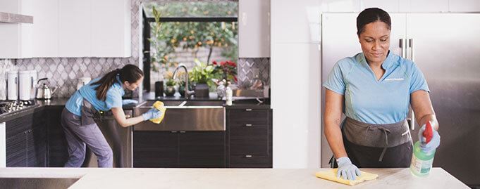 Merry Maids of Locust Grove house cleaners sanitizing a kitchen