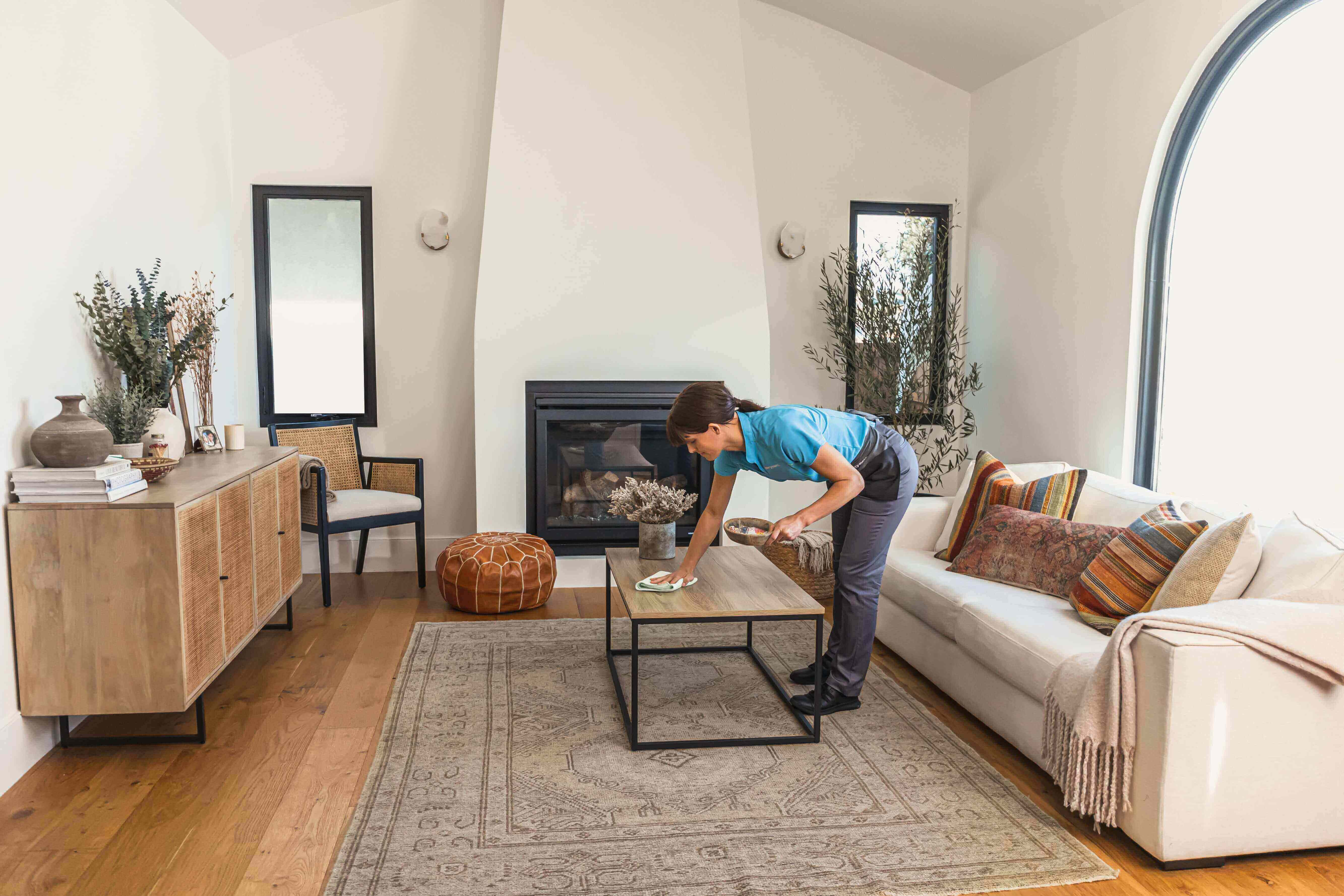 Merry Maids Employee Cleaning Living Room