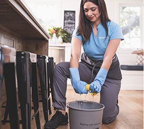 A Merry Maids team member deep cleaning a kitchen in Conyers, Georgia